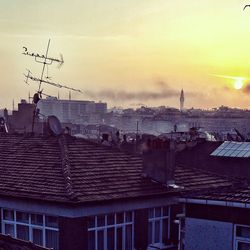 High section of city against sky during sunset