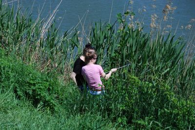 High angle view of women sitting on grass