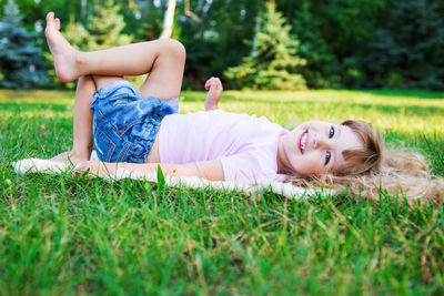 Portrait of smiling girl lying down on land