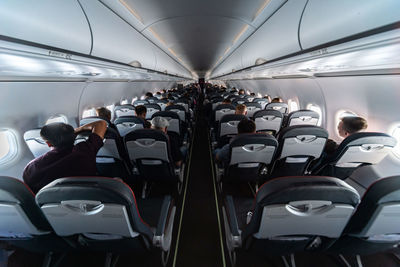 Rear view of people sitting in airplane