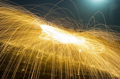 Wire wool spinning over field at night