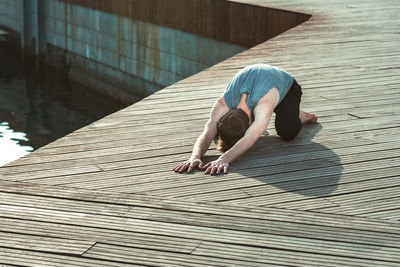 High angle view of person relaxing on wood