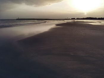 Scenic view of beach against sky during sunset