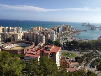 High angle view of buildings and sea against sky