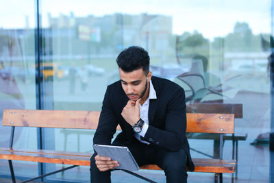 Young businessman looking at digital tablet