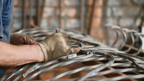 Close-up of man working on metal