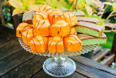 Close-up of dessert on cakestand at table