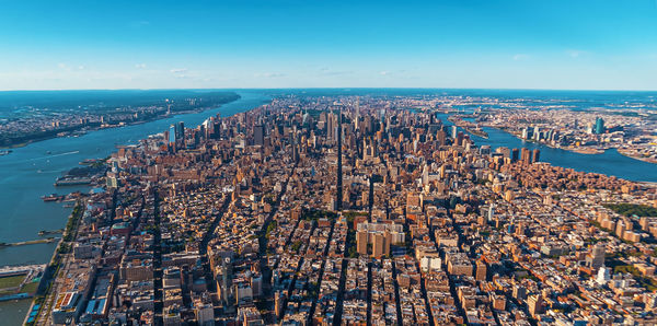 Aerial view of buildings and sea against sky