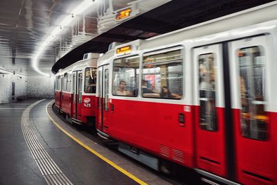 Train moving on illuminated railroad station