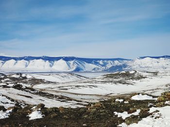 Scenic view of snowcapped mountains against sky