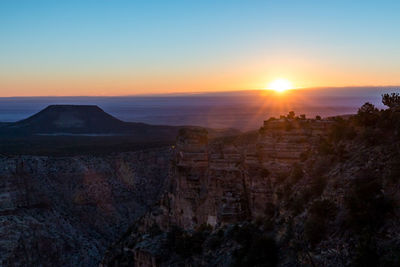 Scenic view of rocky mountains against sky during sunset