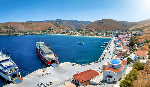 High angle view of townscape by sea against sky