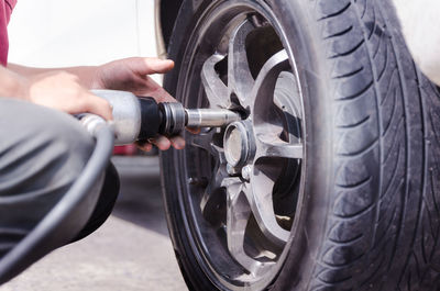 Midsection of man repairing car