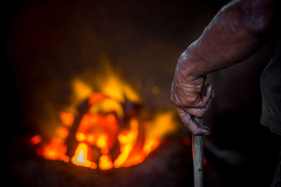 Close-up of hand holding bonfire