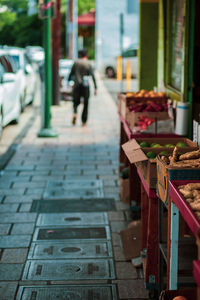 Man walking on footpath in city