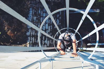 Directly above shot of man climbing ladder