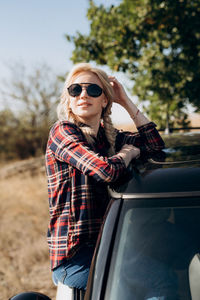 Young woman sitting in sunglasses
