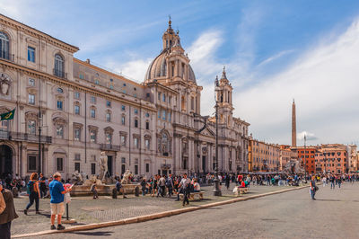 Group of people in front of buildings in city