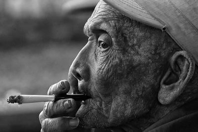 Close-up portrait of man smoking cigarette