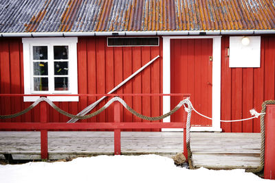 Red and house against building during winter