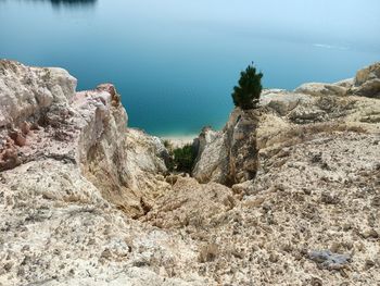 High angle view of rocks on beach against sky