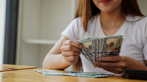 Midsection of a woman holding blue table