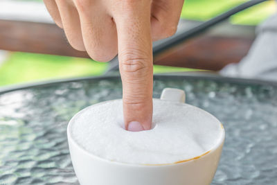 Close-up of person hand holding glass