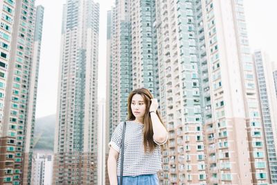 Portrait of woman standing by railing