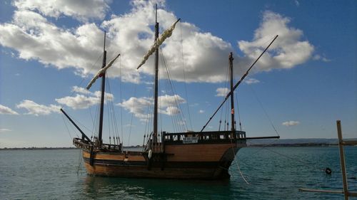 Sailboats in sea against sky