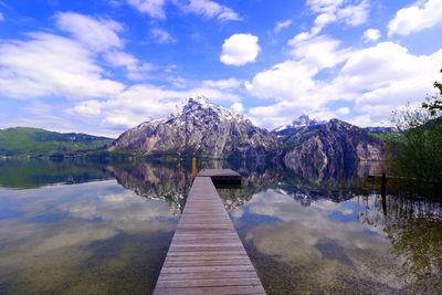 Scenic view of pier on lake against sky