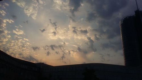 Low angle view of silhouette building against sky