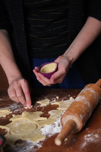 Cropped hands of woman holding sushi