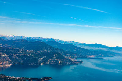 Scenic view of sea and mountains against sky