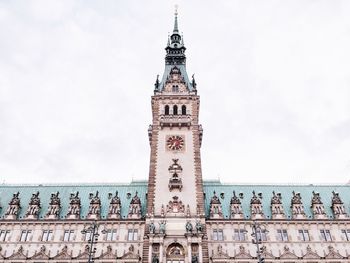 Clock tower against cloudy sky