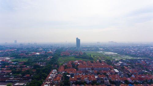 High angle view of buildings in city against sky