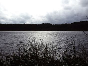 Scenic view of lake against cloudy sky