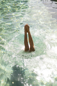 Woman jumping in pool 