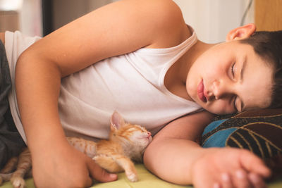 Baby girl lying on bed at home