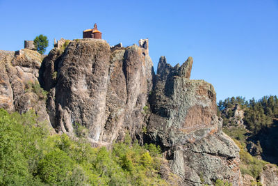 The fragments of walls and the chapel castrale in red stone of arlempdes in haute-loire 