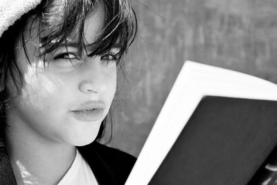 Close-up portrait of beautiful woman with book