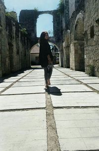 Full length of woman standing by railing