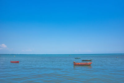 Boat in sea against blue sky