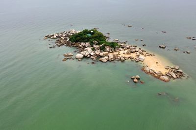 High angle view of rocks on sea shore