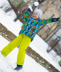 Low angle view of girl playing in snow