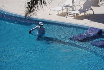 High angle view of man swimming in pool