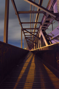 Footbridge with shadow against sky