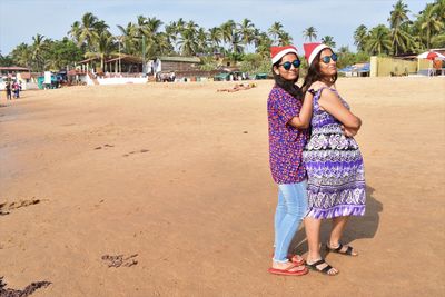 Full length portrait of woman standing on beach