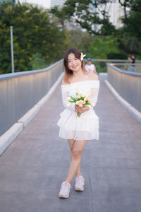 Young woman standing on footbridge