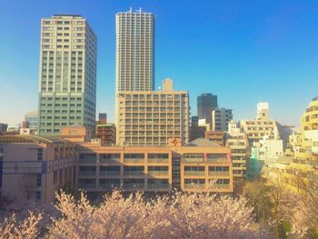 Modern buildings against clear blue sky