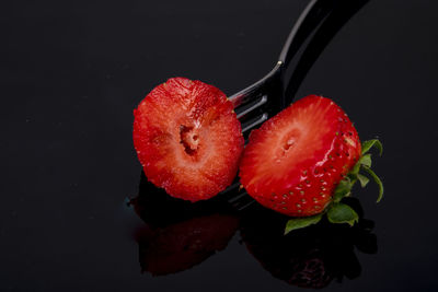 High angle view of strawberries on black background